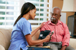 elderly man having his blood pressure checked